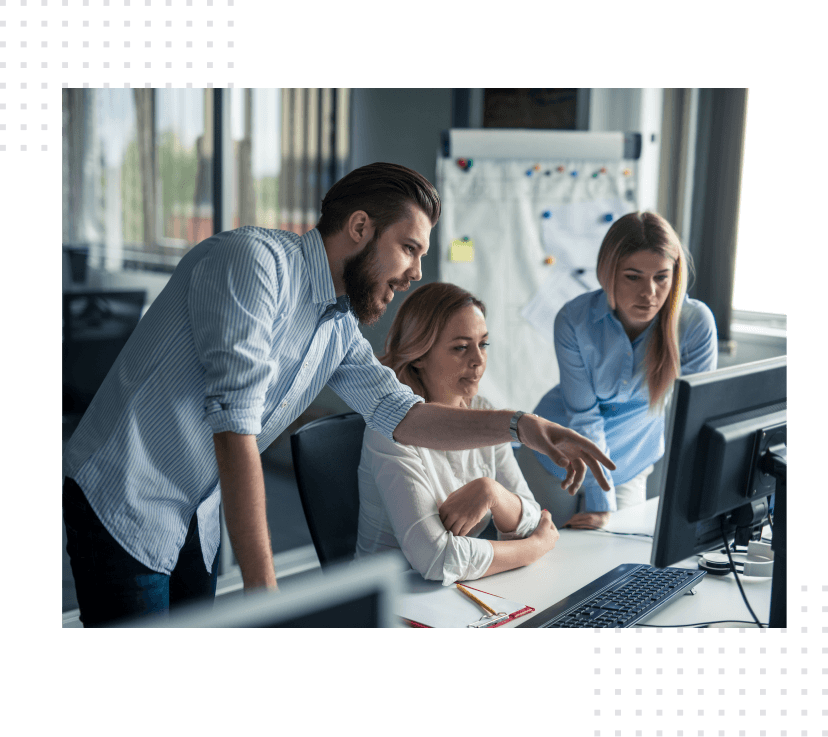 Dedicated team working on a project and looking at a computer screen